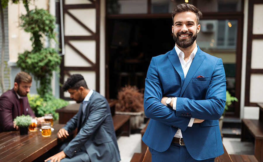 Young male business owner standing near his new local. Startup, entrepreneur, business concept.