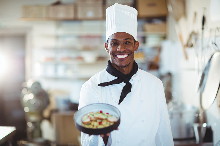 Portrait of head chef presenting salad