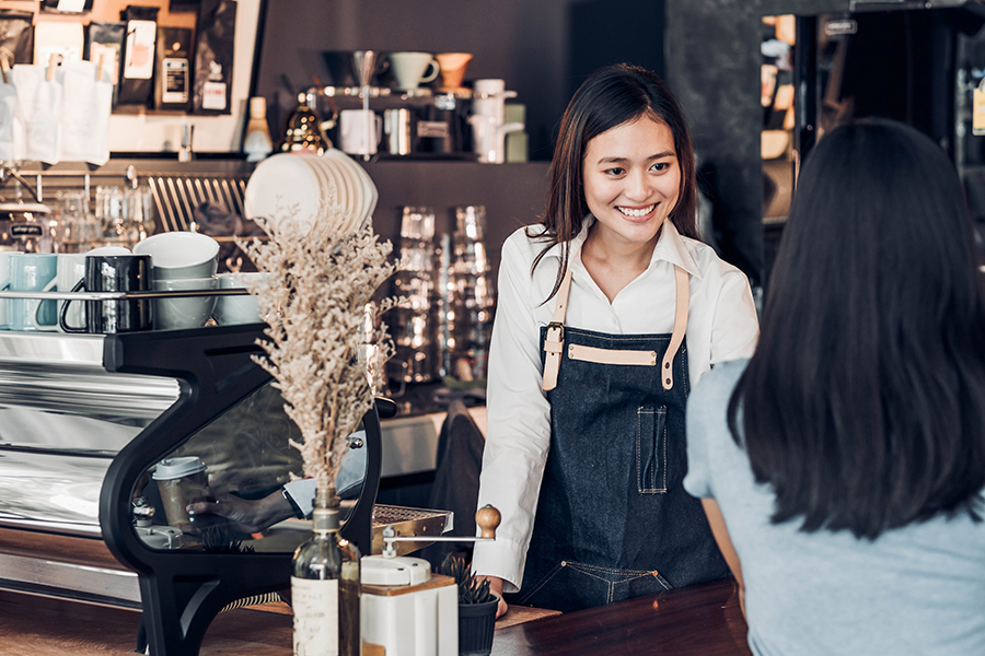 Asian Woman Barista Wear Jean Apron Holding Coffee Cup Served To
