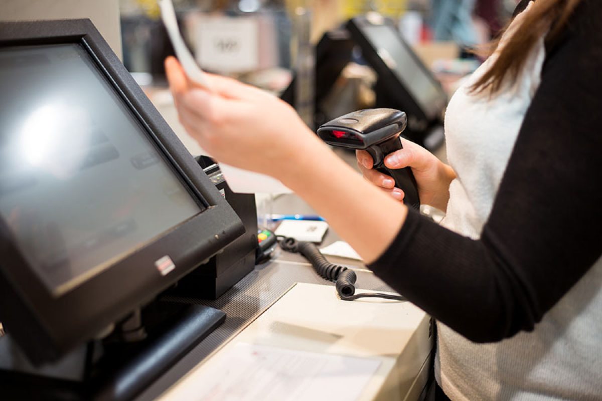 person using a POS system and barcode scanner